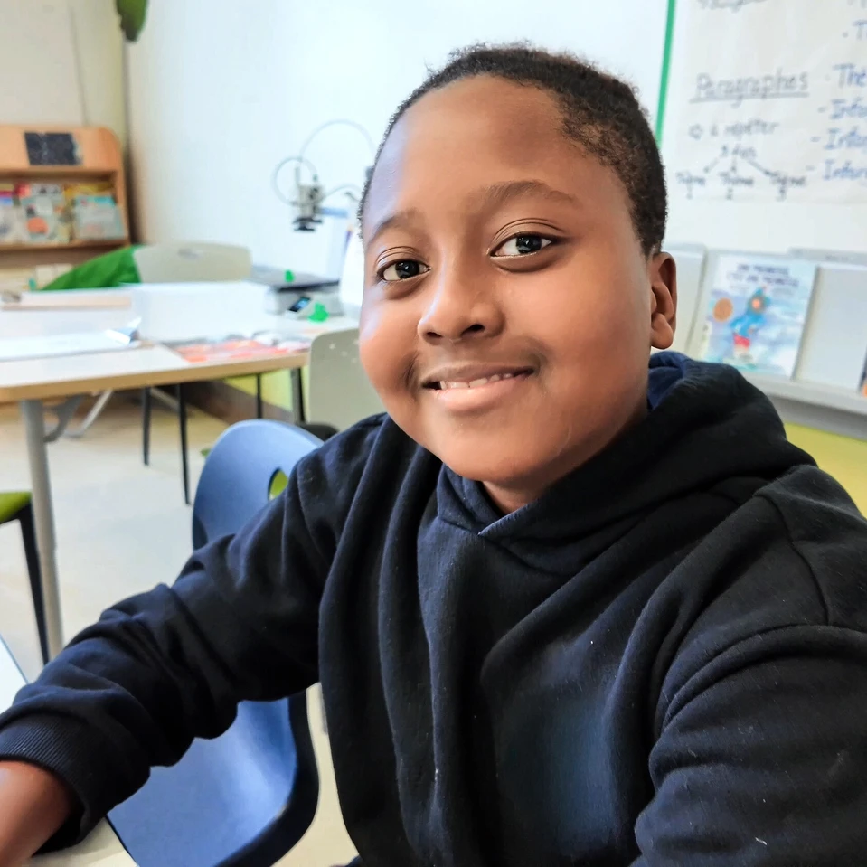 élève garçon souriant en salle de classe